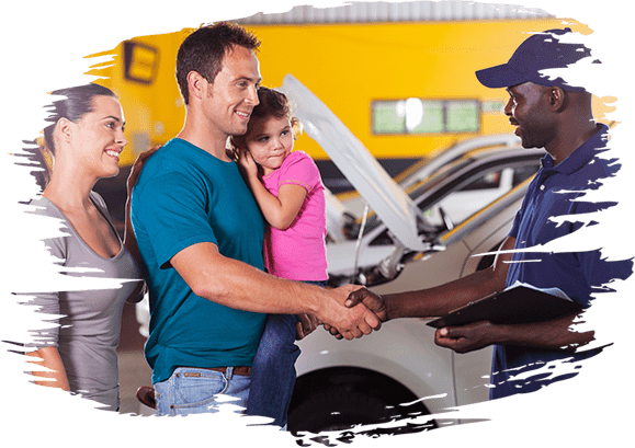 friendly auto mechanic handshaking with family inside workshop